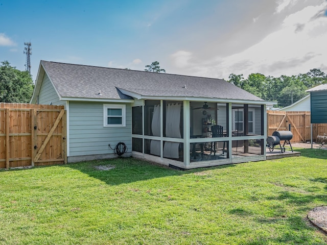 9 Pirates Cove Ln, Saint Marks, FL 32355 - rear view of house with a gate, a shingled roof, a sunroom, and a fenced backyard