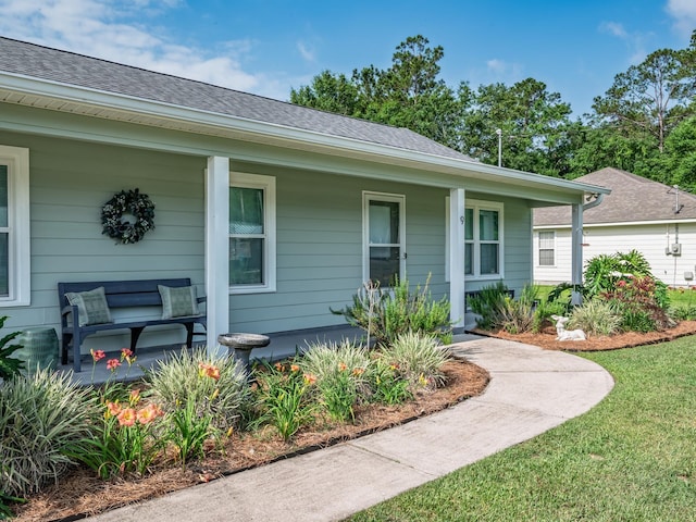 9 Pirates Cove Ln, Saint Marks, FL 32355 - view of exterior entry with a porch and roof with shingles