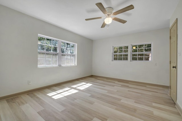 unfurnished room featuring baseboards, light wood finished floors, and ceiling fan