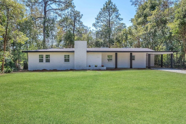 view of front of property with an attached carport and a front lawn