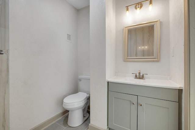 bathroom featuring visible vents, baseboards, toilet, tile patterned floors, and vanity