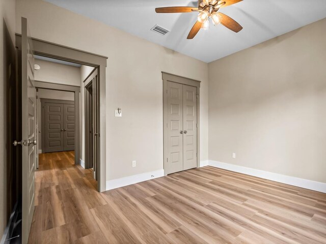 1673 Landing St, Carrabelle, FL 32322 - unfurnished bedroom featuring light wood-style floors, baseboards, a closet, and ceiling fan