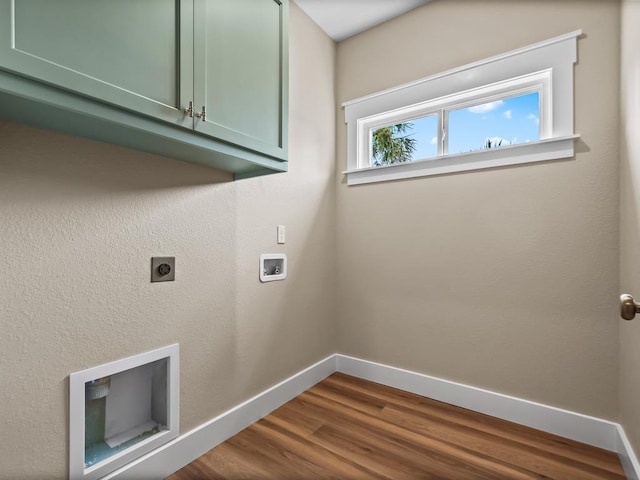 1673 Landing St, Carrabelle, FL 32322 - washroom with cabinet space, baseboards, washer hookup, electric dryer hookup, and dark wood-style flooring