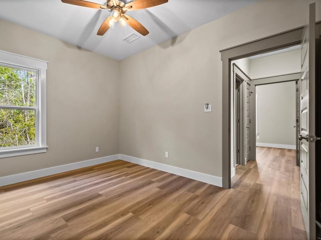 1673 Landing St, Carrabelle, FL 32322 - spare room featuring light wood-style flooring, a ceiling fan, and baseboards