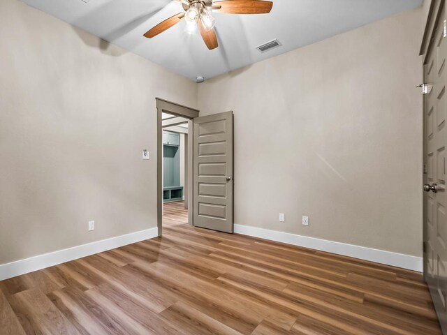 1673 Landing St, Carrabelle, FL 32322 - unfurnished bedroom featuring baseboards, light wood-type flooring, and ceiling fan