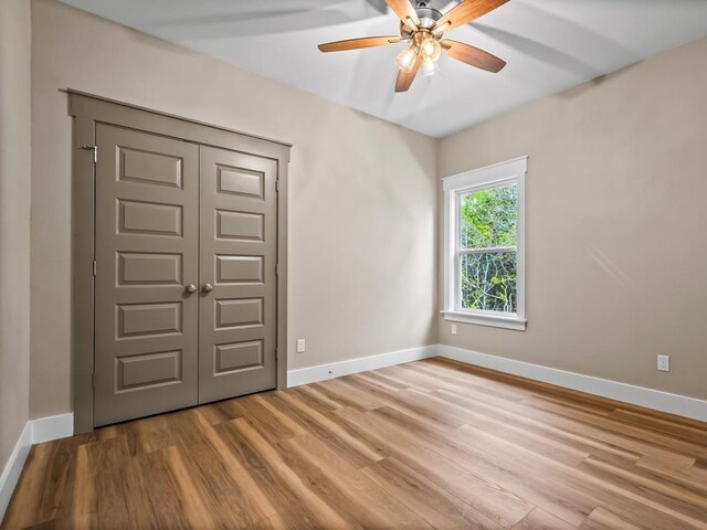 1673 Landing St, Carrabelle, FL 32322 - unfurnished bedroom with wood finished floors, baseboards, and a closet