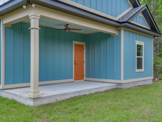1673 Landing St, Carrabelle, FL 32322 - entrance to property with a lawn, a ceiling fan, board and batten siding, and roof with shingles