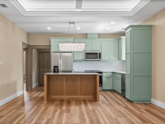 1673 Landing St, Carrabelle, FL 32322 - kitchen with stainless steel appliances, green cabinets, a kitchen island, baseboards, and light wood-type flooring