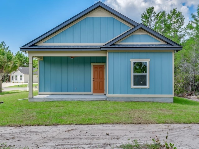 1673 Landing St, Carrabelle, FL 32322 - bungalow-style house featuring a front yard and board and batten siding