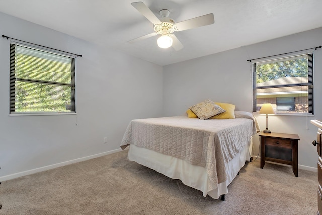 bedroom with ceiling fan and light colored carpet