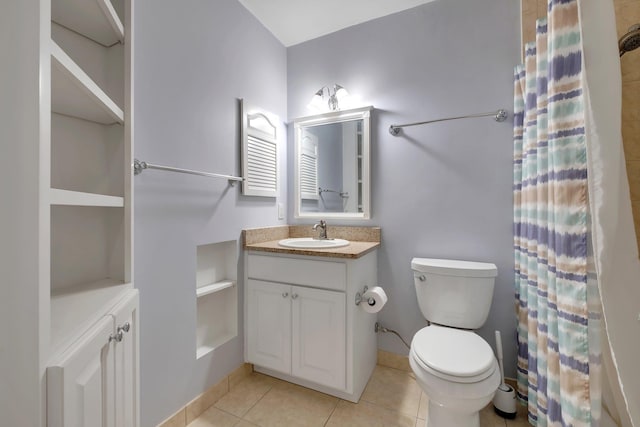 bathroom with vanity, toilet, and tile patterned flooring