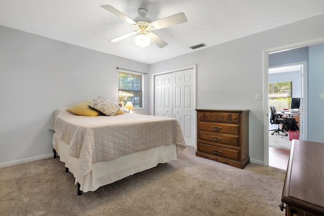 carpeted bedroom with a closet and ceiling fan