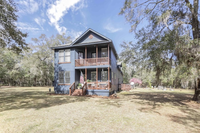 view of front of house featuring a balcony and a front lawn