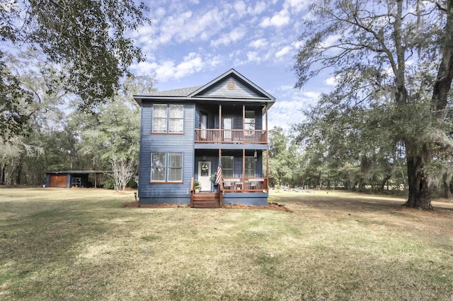 view of front of home with covered porch, a front yard, and a balcony