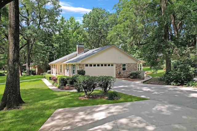 2948 Edenderry Dr, Tallahassee, FL 32309 - view of side of property featuring a chimney, a yard, brick siding, an attached garage, and driveway