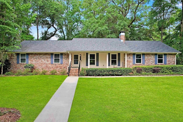 2948 Edenderry Dr, Tallahassee, FL 32309 - single story home with a chimney, a front yard, brick siding, and covered porch