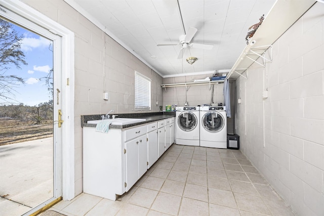 laundry area with sink, light tile patterned floors, washer and clothes dryer, ceiling fan, and cabinets