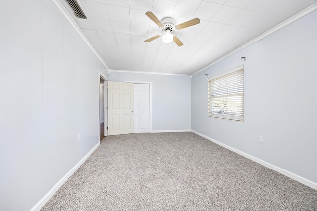 carpeted empty room with ornamental molding and ceiling fan