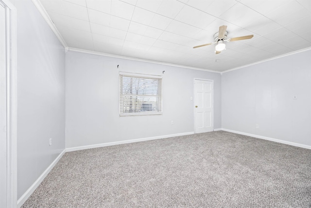 carpeted spare room with ceiling fan and ornamental molding