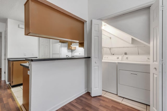 2467 Nugget Ln, Tallahassee, FL 32303 - laundry area featuring separate washer and dryer, light wood-style floors, and baseboards