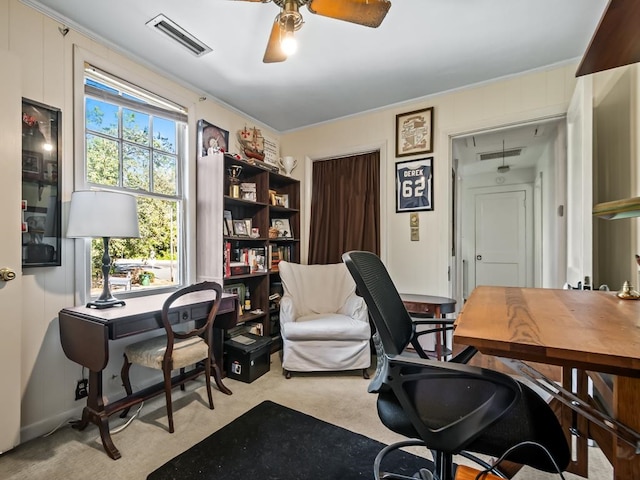 office space featuring light carpet and ceiling fan