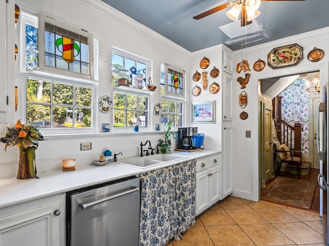 kitchen with crown molding, white cabinetry, sink, stainless steel dishwasher, and ceiling fan