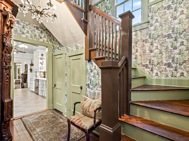 staircase with vaulted ceiling and tile patterned floors