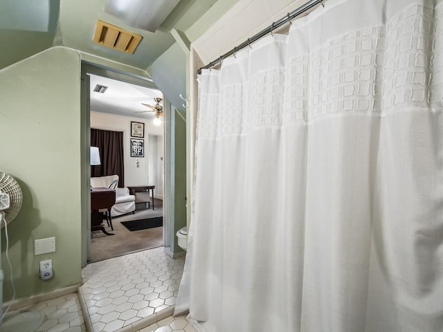 bathroom featuring ceiling fan and tile patterned flooring