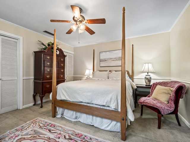 bedroom featuring light colored carpet, ceiling fan, a closet, and ornamental molding