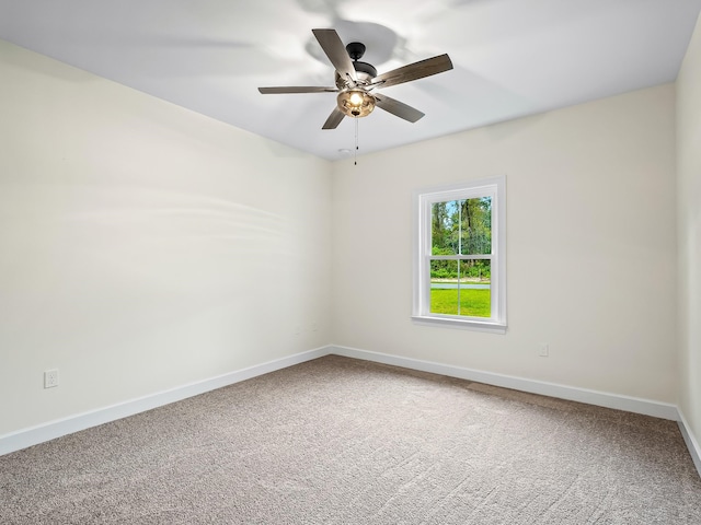 carpeted empty room featuring ceiling fan