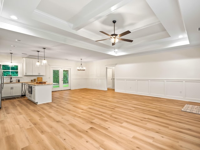 kitchen featuring light wood-type flooring, hanging light fixtures, and crown molding