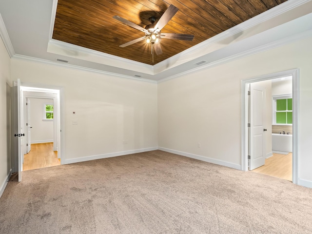 unfurnished room featuring light carpet, wooden ceiling, ornamental molding, ceiling fan, and a tray ceiling