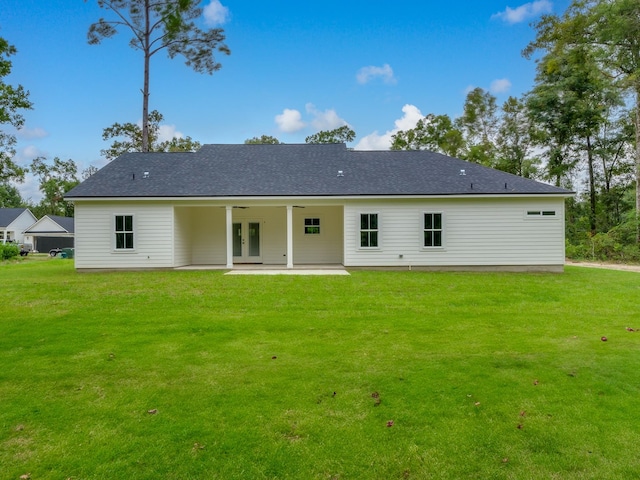 rear view of property with a lawn and a patio area