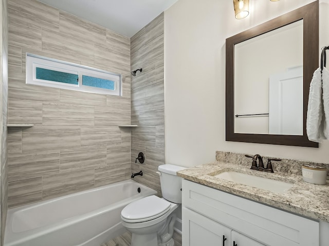 full bathroom with toilet, tiled shower / bath combo, and vanity