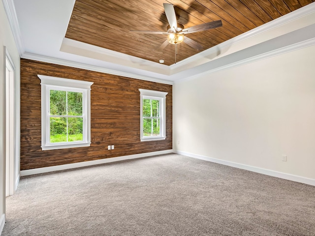 unfurnished room with a tray ceiling, wooden walls, wooden ceiling, and crown molding