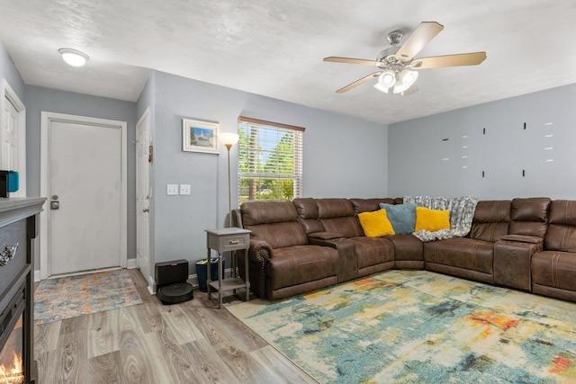 6812 Hill Gail Trl, Tallahassee, FL 32309 - living room with a glass covered fireplace, wood finished floors, and ceiling fan
