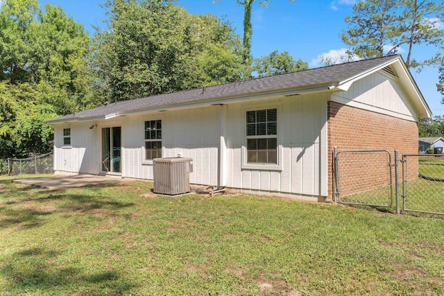 6812 Hill Gail Trl, Tallahassee, FL 32309 - back of property featuring central air condition unit, a gate, brick siding, and roof with shingles