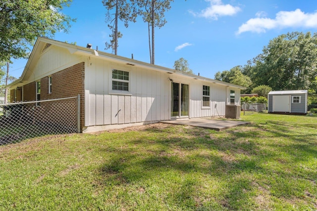 6812 Hill Gail Trl, Tallahassee, FL 32309 - rear view of property with a shed, an outdoor structure, a patio, board and batten siding, and brick siding