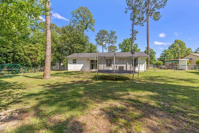 6812 Hill Gail Trl, Tallahassee, FL 32309 - back of property featuring a trampoline and a playground
