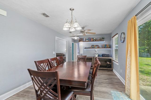 6812 Hill Gail Trl, Tallahassee, FL 32309 - dining space featuring a chandelier, baseboards, wood finished floors, and a ceiling fan