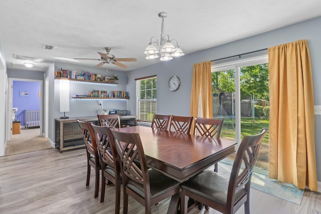 6812 Hill Gail Trl, Tallahassee, FL 32309 - dining space with light wood-style floors, ceiling fan, radiator, a chandelier, and baseboards
