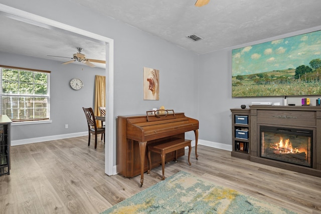 6812 Hill Gail Trl, Tallahassee, FL 32309 - living area with a ceiling fan, baseboards, wood finished floors, and a glass covered fireplace