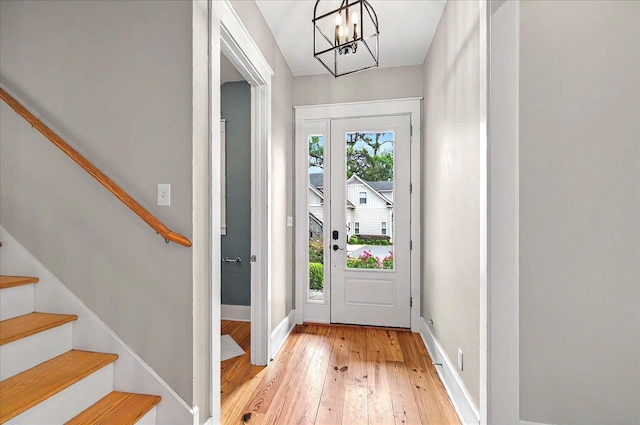 1261 Myrtle View Dr, Tallahassee, FL 32312 - doorway to outside featuring baseboards, light wood-style flooring, a notable chandelier, and stairway