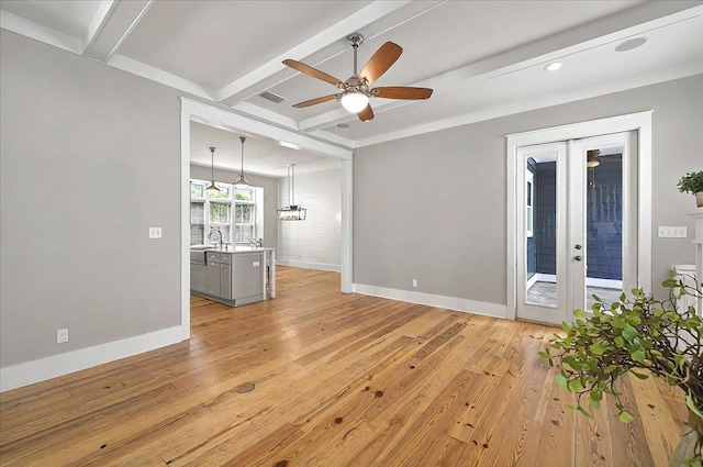 1261 Myrtle View Dr, Tallahassee, FL 32312 - unfurnished living room featuring a ceiling fan, french doors, light wood-type flooring, beam ceiling, and baseboards