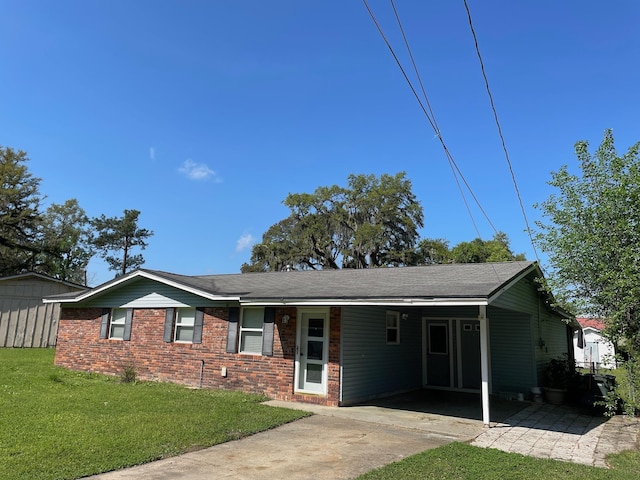 320 Lancaster Dr, Tallahassee, FL 32304 - ranch-style house with a carport, concrete driveway, roof with shingles, a front yard, and brick siding