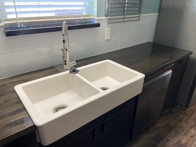 320 Lancaster Dr, Tallahassee, FL 32304 - details with dark countertops, dark cabinets, backsplash, and a sink