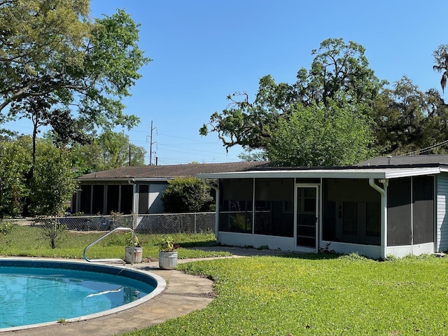 320 Lancaster Dr, Tallahassee, FL 32304 - back of property with a fenced in pool, a sunroom, a lawn, and fence