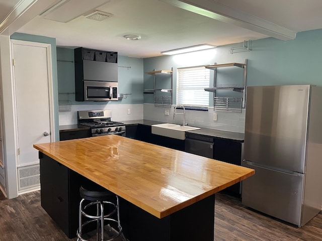 320 Lancaster Dr, Tallahassee, FL 32304 - kitchen with open shelves, appliances with stainless steel finishes, wooden counters, a sink, and dark wood-type flooring