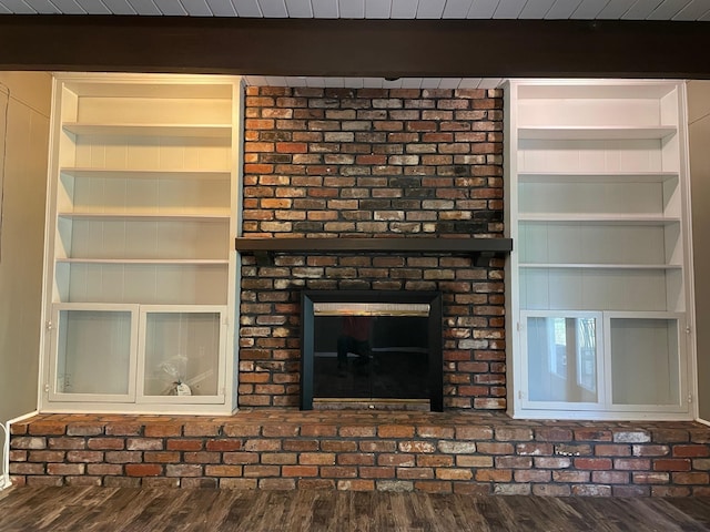 320 Lancaster Dr, Tallahassee, FL 32304 - unfurnished living room with built in features, wood finished floors, and beam ceiling
