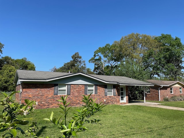 320 Lancaster Dr, Tallahassee, FL 32304 - ranch-style house featuring a front lawn, a carport, and brick siding